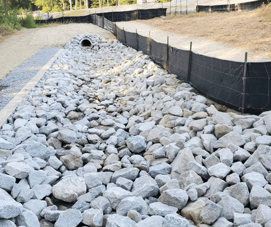 Rip-rap reinforced channel stabilizing a site