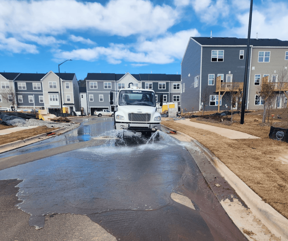 Street washing removing sediment from a road at a North Carolina construction entrance