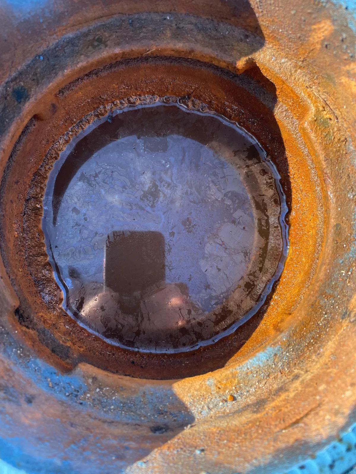 Close-up of a water valve clogged with debris before cleaning