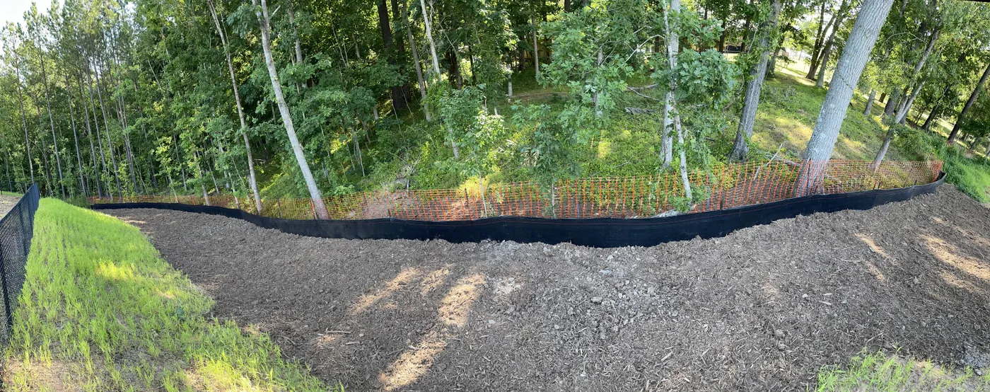 Silt fence installed along a wooded North Carolina construction site